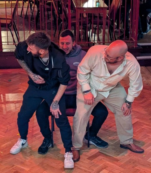 Three men having fun on the dancefloor at The Welsh Social Club, Hereford